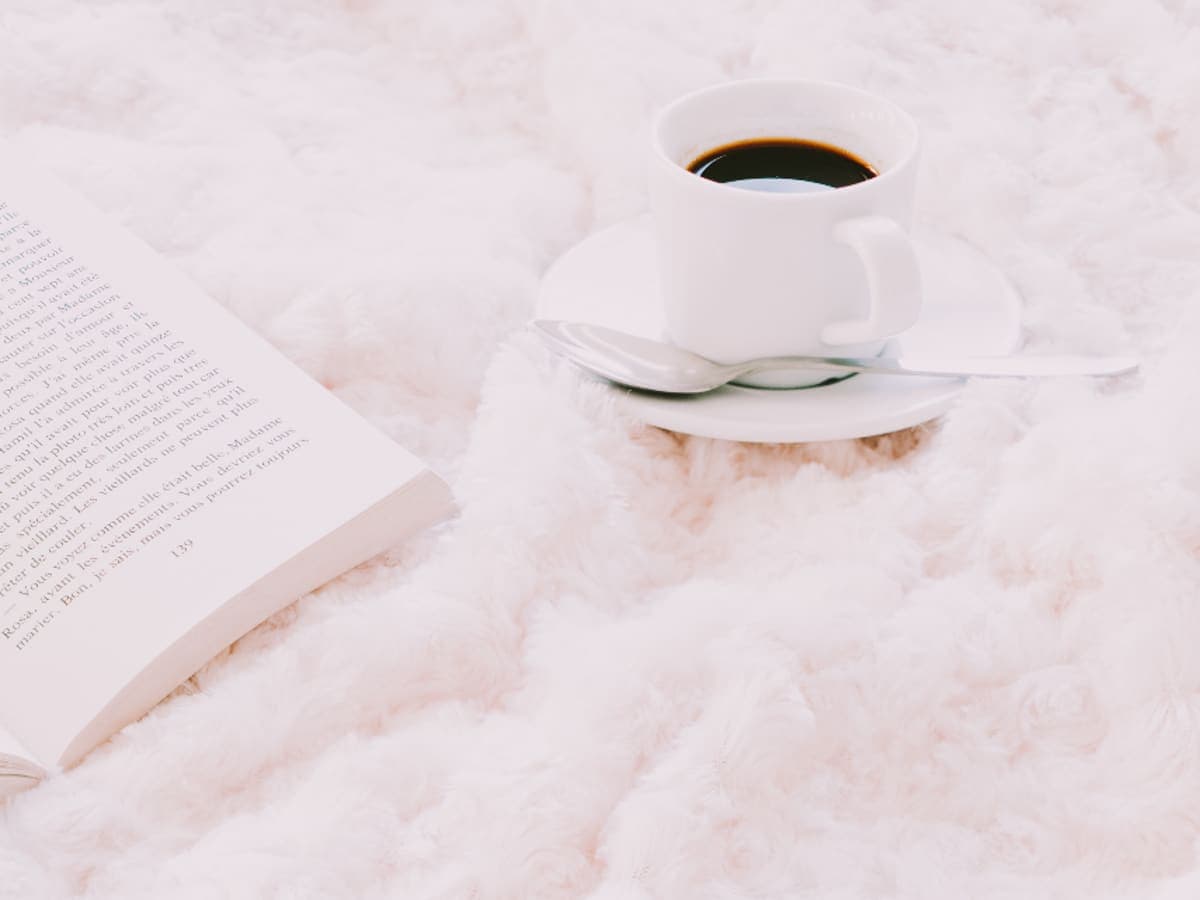 A cup resting on a soft white blanket.